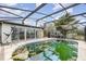 Exterior view of a screened-in swimming pool surrounded by a patio and partial view of the house at 1962 English Dr, Deltona, FL 32738