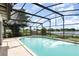 Enjoy this inviting in ground pool in a screened enclosure, and views of the lake beyond at 1962 English Dr, Deltona, FL 32738