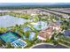 Aerial view of community pool and lake with surrounding homes at 1979 Majorca Dr, Kissimmee, FL 34747