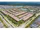 Extensive community with a central lake, a pool, landscaping, and numerous townhomes at 1979 Majorca Dr, Kissimmee, FL 34747