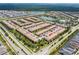 Extensive community with a central lake, a pool, landscaping, and numerous townhomes at 1979 Majorca Dr, Kissimmee, FL 34747