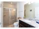 Modern bathroom showcasing a glass-enclosed shower and a sleek vanity with granite countertops at 1979 Majorca Dr, Kissimmee, FL 34747