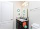 Well-lit bathroom features a granite vanity, decorative wall art, and a modern towel rack at 1979 Majorca Dr, Kissimmee, FL 34747
