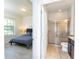 Bathroom and bedroom featuring modern fixtures, a glass-enclosed shower, and a comfortable bedroom suite at 1979 Majorca Dr, Kissimmee, FL 34747