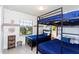 Nicely decorated bedroom with bunkbeds, featuring a window bringing in natural light at 1979 Majorca Dr, Kissimmee, FL 34747