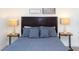 Comfortable bedroom featuring a dark wood headboard and two side tables with lamps at 1979 Majorca Dr, Kissimmee, FL 34747