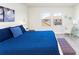 Inviting bedroom featuring a bed with blue bedding, and tasteful decorations, complemented by plentiful natural light at 1979 Majorca Dr, Kissimmee, FL 34747