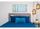 Stylishly decorated bedroom with modern lighting, an artful birch tree print, and accent pillows at 1979 Majorca Dr, Kissimmee, FL 34747