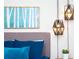 Modern bedroom with contemporary pendant lights, a birch tree art print, and an inviting bed at 1979 Majorca Dr, Kissimmee, FL 34747