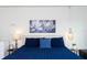 Close up view of Primary bedroom with blue bedding, decorative mirrors, and tasteful decorations at 1979 Majorca Dr, Kissimmee, FL 34747