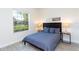 Cozy bedroom featuring a comfortable bed, a large window, and warm, inviting decor at 1979 Majorca Dr, Kissimmee, FL 34747