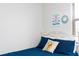 Comfortable bedroom features a twin bed with bright colored pillows and a view from the window at 1979 Majorca Dr, Kissimmee, FL 34747