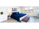 Bright bedroom boasts a comfortable bed with blue bedding, complemented by stylish decor and ample natural light at 1979 Majorca Dr, Kissimmee, FL 34747