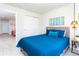 Bright bedroom features a comfortable bed, pendant lights, and offers easy access to other rooms at 1979 Majorca Dr, Kissimmee, FL 34747