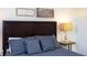 Inviting bedroom featuring a dark wood headboard, soft pillows, and decorative wall art at 1979 Majorca Dr, Kissimmee, FL 34747