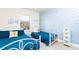 Charming bedroom with twin beds features a mermaid-themed accent wall and a bright window at 1979 Majorca Dr, Kissimmee, FL 34747