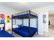 Cozy bedroom featuring fun bunkbeds with blue bedding and unique racing decor for a playful atmosphere at 1979 Majorca Dr, Kissimmee, FL 34747