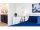 Bright bedroom with blue bedding, stylish furniture, and adjoining bathroom, creating a comfortable, functional space at 1979 Majorca Dr, Kissimmee, FL 34747