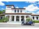 Front facade of community clubhouse with golf cart parked nearby, manicured landscaping and sidewalks at 1979 Majorca Dr, Kissimmee, FL 34747