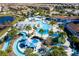 Aerial shot of pool area including lazy river, cabanas, swimming pool, slide and plenty of lounge seating at 1979 Majorca Dr, Kissimmee, FL 34747