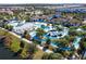 High angle shot of an elaborate community pool area, featuring slides, cabanas, lazy river, and lounge seating at 1979 Majorca Dr, Kissimmee, FL 34747