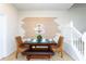 Inviting dining area featuring a modern table, stylish decor, and access to the staircase at 1979 Majorca Dr, Kissimmee, FL 34747