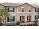 Charming townhome with black shutters, tile roof, and an inviting front entry with covered seating area at 1979 Majorca Dr, Kissimmee, FL 34747