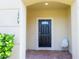 Charming front entryway with a black door, brick floor, and a welcoming ambiance at 1979 Majorca Dr, Kissimmee, FL 34747