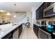 Open-concept kitchen with stainless appliances, a view of the staircase, and granite countertops at 1979 Majorca Dr, Kissimmee, FL 34747