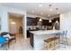 Modern kitchen boasts an island with seating, stainless steel appliances, and stylish cabinetry at 1979 Majorca Dr, Kissimmee, FL 34747