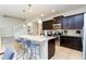 Well lit kitchen showcasing stainless steel appliances, a large island, and dark wood cabinetry at 1979 Majorca Dr, Kissimmee, FL 34747