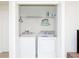 Convenient laundry closet equipped with modern washer and dryer units and an ironing board at 1979 Majorca Dr, Kissimmee, FL 34747