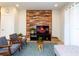 Cozy living room features wood accent wall, plush seating, and stylish decor for comfortable living at 1979 Majorca Dr, Kissimmee, FL 34747