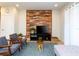 Cozy living room features wood accent wall, plush seating, and stylish decor for comfortable living at 1979 Majorca Dr, Kissimmee, FL 34747