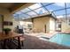 Screened pool patio featuring BBQ, seating, brick pavers, and relaxing atmosphere at 1979 Majorca Dr, Kissimmee, FL 34747