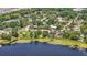Picturesque view of a lakeside community with lush trees, charming homes, and scenic waterfront vistas at 2028 Lake Christie Dr, Orlando, FL 32809
