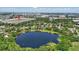 Beautiful aerial view of the lake surrounded by trees, houses, and buildings at 2028 Lake Christie Dr, Orlando, FL 32809