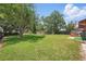 Large backyard featuring a well-maintained lawn and fence at 2028 Lake Christie Dr, Orlando, FL 32809
