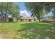 Spacious backyard featuring a green lawn and privacy fences at 2028 Lake Christie Dr, Orlando, FL 32809