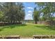 Scenic backyard featuring a green lawn and peaceful lake view at 2028 Lake Christie Dr, Orlando, FL 32809