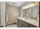 Bathroom featuring textured wallpaper, a shower and bath tub, and a tile floor at 2028 Lake Christie Dr, Orlando, FL 32809