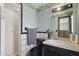 Bathroom with a shower and toilet as well as decorative wallpaper and a black and white tile at 2028 Lake Christie Dr, Orlando, FL 32809