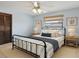 Staged bedroom with a bed, ceiling fan, louvered closet doors, window, and carpeted floor at 2028 Lake Christie Dr, Orlando, FL 32809