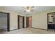 Neutral bedroom with a ceiling fan, double closets, access to a bathroom, and carpeted floor at 2028 Lake Christie Dr, Orlando, FL 32809