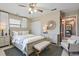Well decorated bedroom with a neutral palette featuring a queen-size bed and seating area at 2028 Lake Christie Dr, Orlando, FL 32809