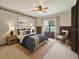 Staged bedroom with an area rug, wood paneled accent wall, side tables and stylish lamps at 2028 Lake Christie Dr, Orlando, FL 32809