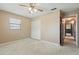 Bedroom with carpeted floor, window, closet with louvered doors, and en suite access at 2028 Lake Christie Dr, Orlando, FL 32809