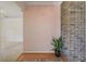 Foyer with a brick accent wall and plant. Hardwood transitions to carpeted rooms at 2028 Lake Christie Dr, Orlando, FL 32809
