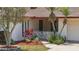 Home with well-kept landscaping, red mulch, and stone accents at 2028 Lake Christie Dr, Orlando, FL 32809