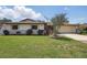 Charming home with a well-manicured lawn, stone accents, and a two-car garage at 2028 Lake Christie Dr, Orlando, FL 32809